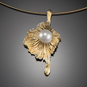 Alexandra Vali's 20k gold de'salanum pendant with a white Akoya pearl